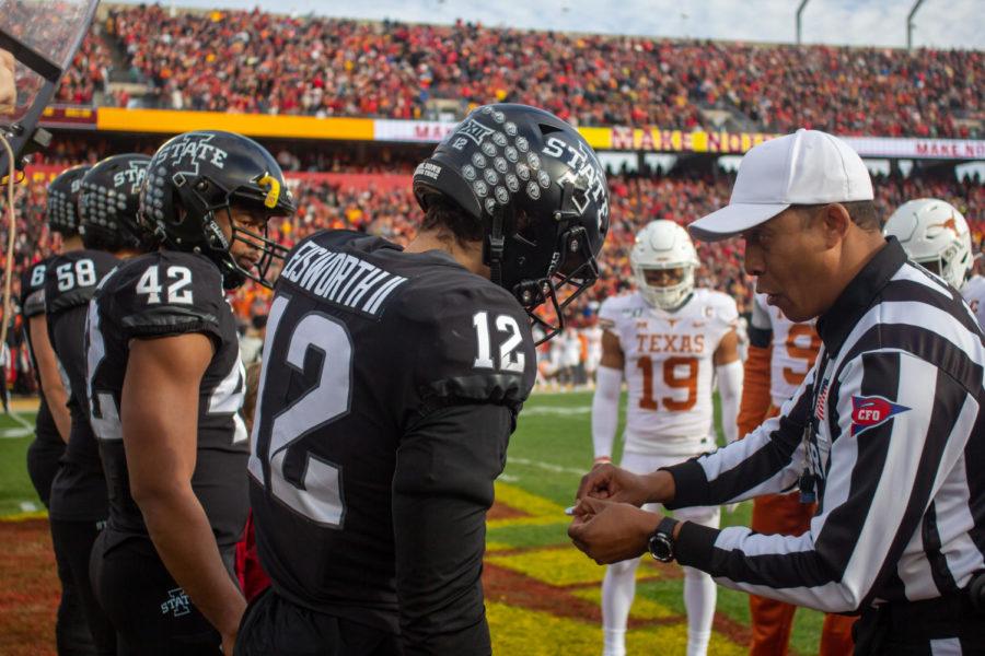 Greg Eisworth talks with an official as Iowa State wins the toss against the University of Texas on Nov. 16. Iowa State won 23-21.