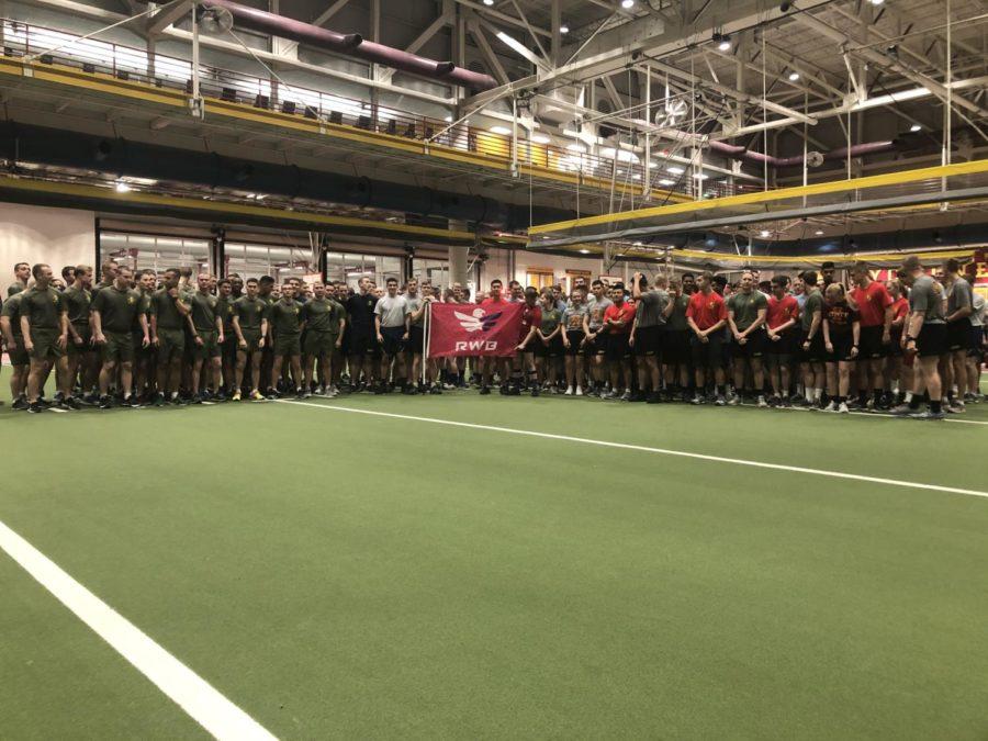 Attendees of the Work Out of the Day event pose together before a 22 minute workout to raise awareness on veteran suicides.
