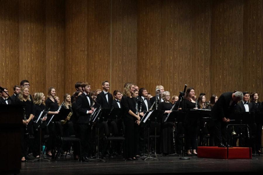 Wind Ensemble director Michael Golemo bowed to the audience in appreciation for their applause at the beginning of their performance at the Iowa State Band Extravaganza on Nov. 10, 2017. 