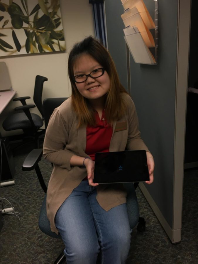 Vanessa Livania, who works for Mind/Body Spa in the Student Services Building, displays one of the iPads used for biofeedback.