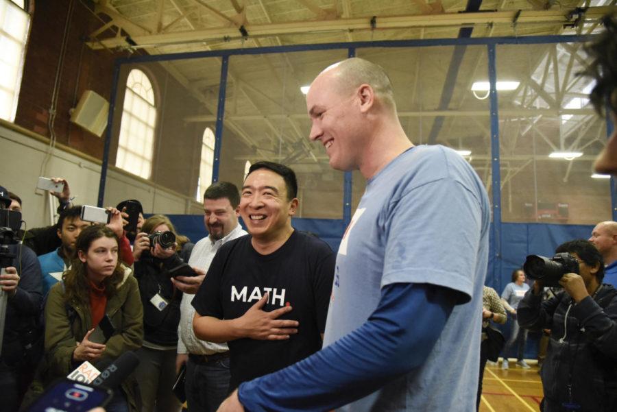 Presidential candidate and businessman Andrew Yang speaks to reporters alongside Democratic congressional candidate J.D. Scholten on Dec. 12 in the Ames Community Center.