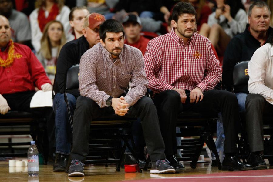 Brent Metcalf (left) and Derek St. John (right) watch the action unfold inside Hilton Coliseum. Iowa defeated Iowa State, 35-6.