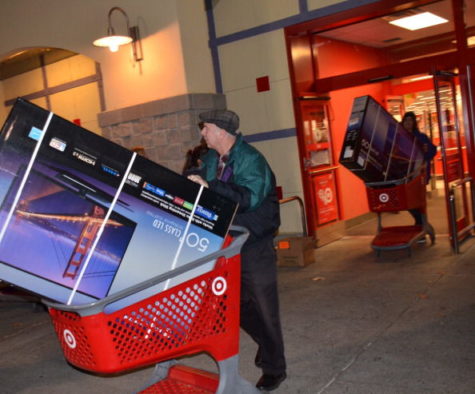Two customers leave Target with 50 flat screen TVs in their shopping carts on Thanksgiving during a Black Friday sale in 2016. 