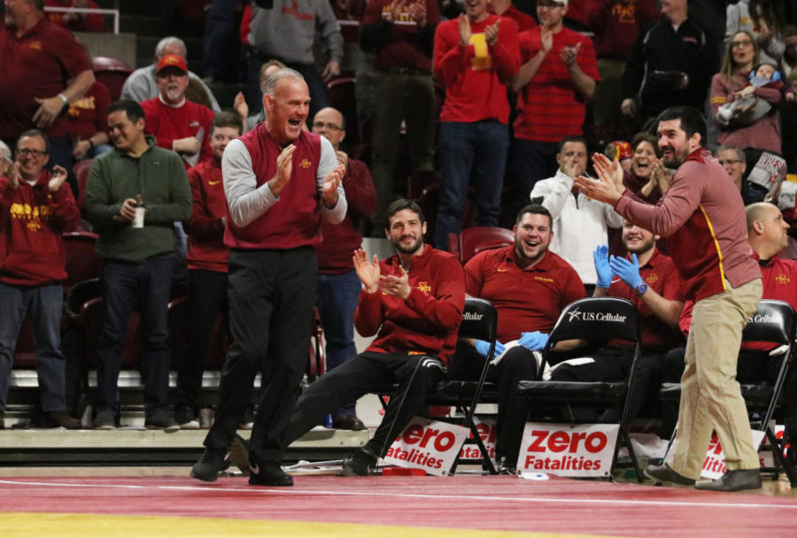 Iowa State wrestling coach Kevin Dresser (left) and assistant coach Brent Metcalf (right) cheer after then-freshman Zane Mulder takes down South Dakota State senior Logan Peterson during their match in the 165-pound weight class. The Iowa State wrestling team won 47-0 against South Dakota State at Hilton Coliseum on Feb. 1.