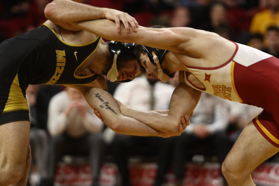 Iowa State then-redshirt sophomore Ian Parker locks up with his opponent during the Cyclones match against Missouri on Feb. 24. The Cyclones lost 15-23.