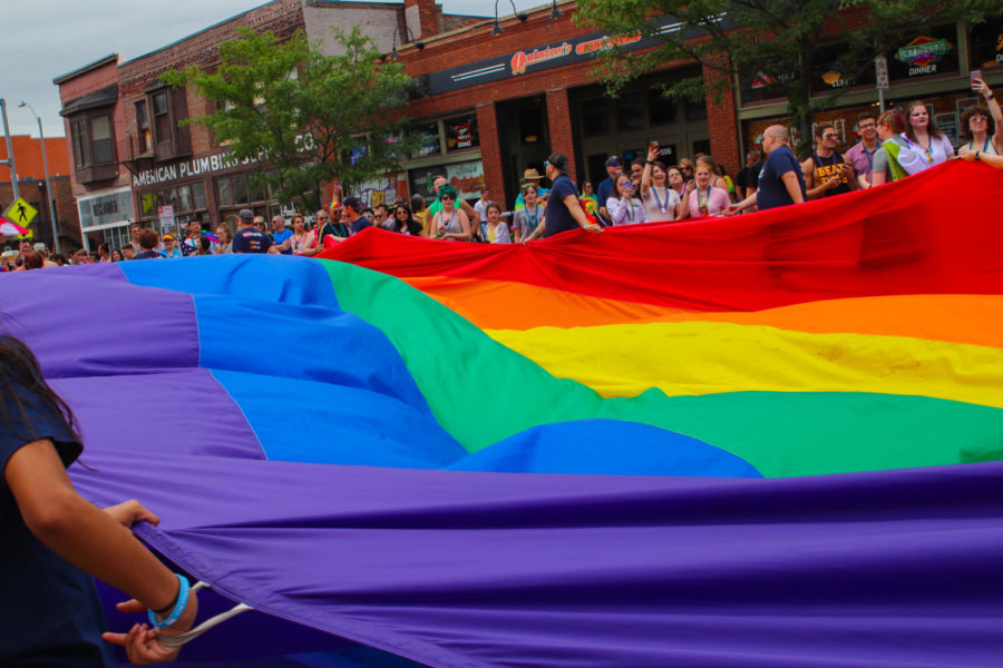 Representatives of U.S. Bank carry a large pride flag across the parade route during the Des Moines Pride Parade on June 9. The parade started at the Iowa Capitol Building and traveled down Grand Avenue in the East Village. 