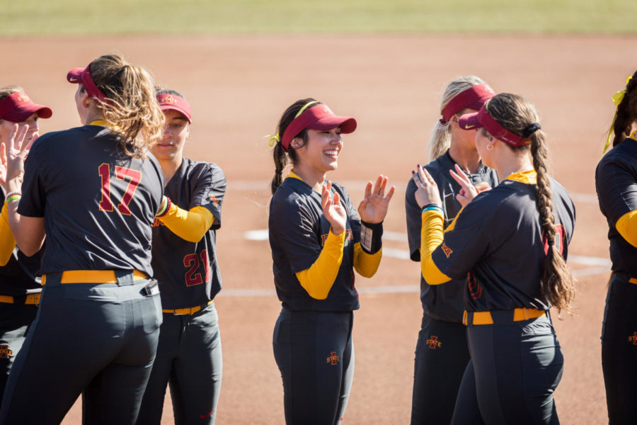 Members of the Iowa State Softball team high five each other during the starting lineup announcements before the start of the Iowa State vs South Dakota softball game held April 2 at the Cyclone Sports Complex. The Cyclones had three home run hits and defeated the Coyotes 9-1.