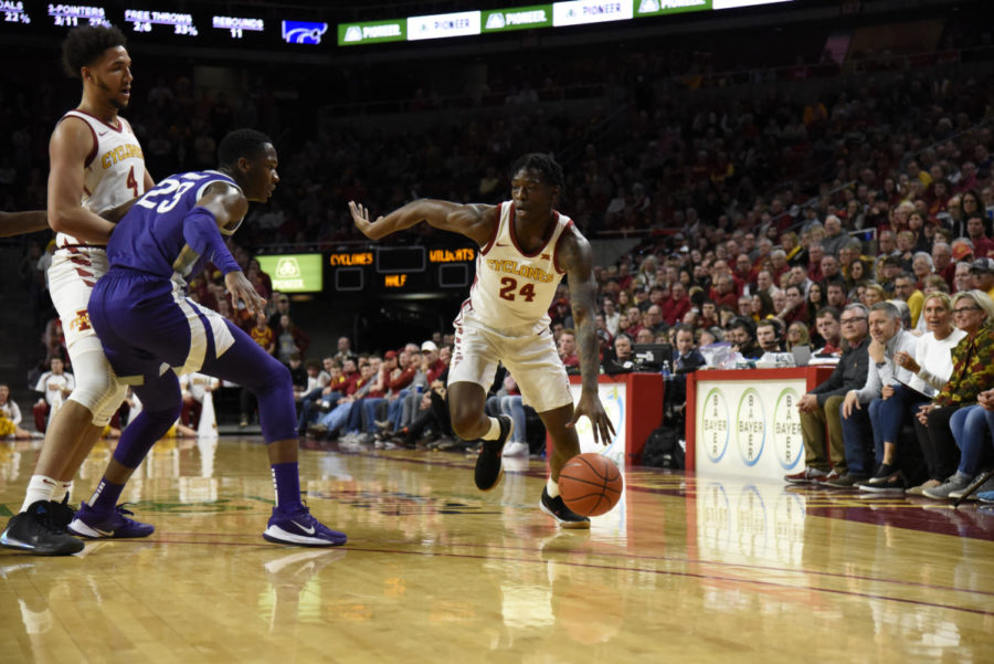 Terrence Lewis uses a George Conditt screen to drive toward the basket against Kansas State on Feb. 8.