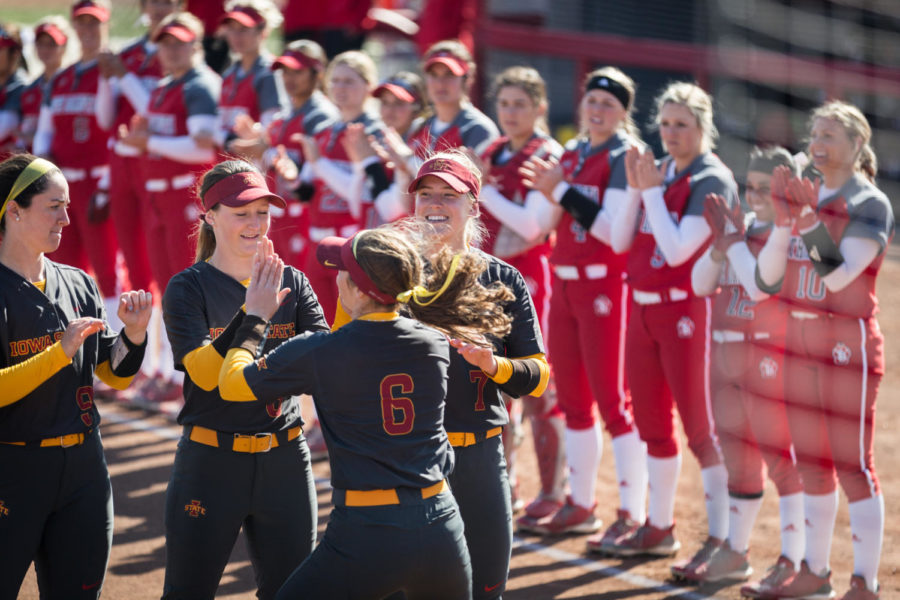 Players clap while the starting lineups are announced before the start of the Iowa State vs. University of South Dakota softball game held at the Cyclone Sports Complex on April 2, 2019. The Cyclones had three home run hits and defeated the Coyotes 9-1.