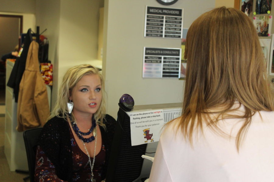 A student speaks with a staff member at Thielen Health Center. 