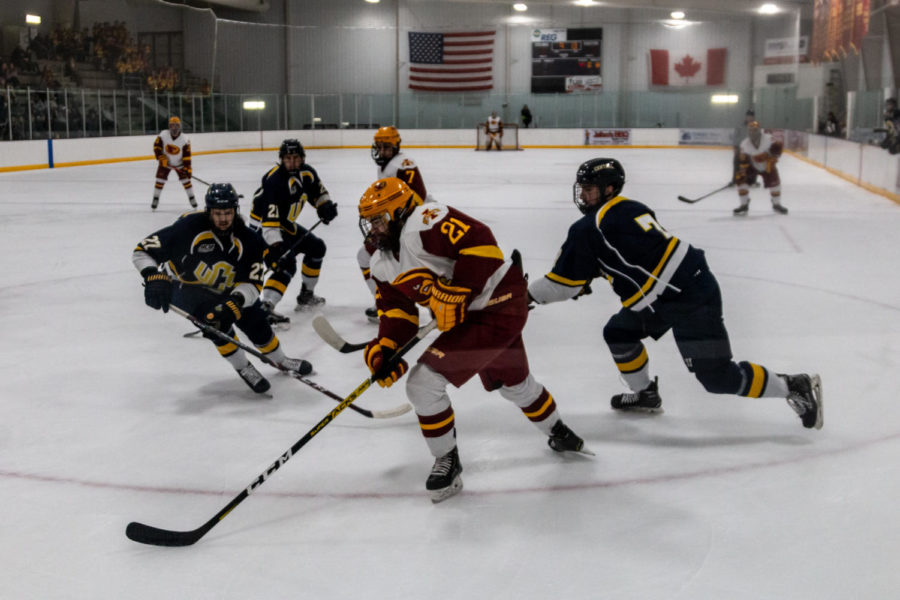 Sophomore Brooks Mitzel chases down a puck in the offensive zone. The Cyclones lost to Central Oklahoma on Feb. 1.
