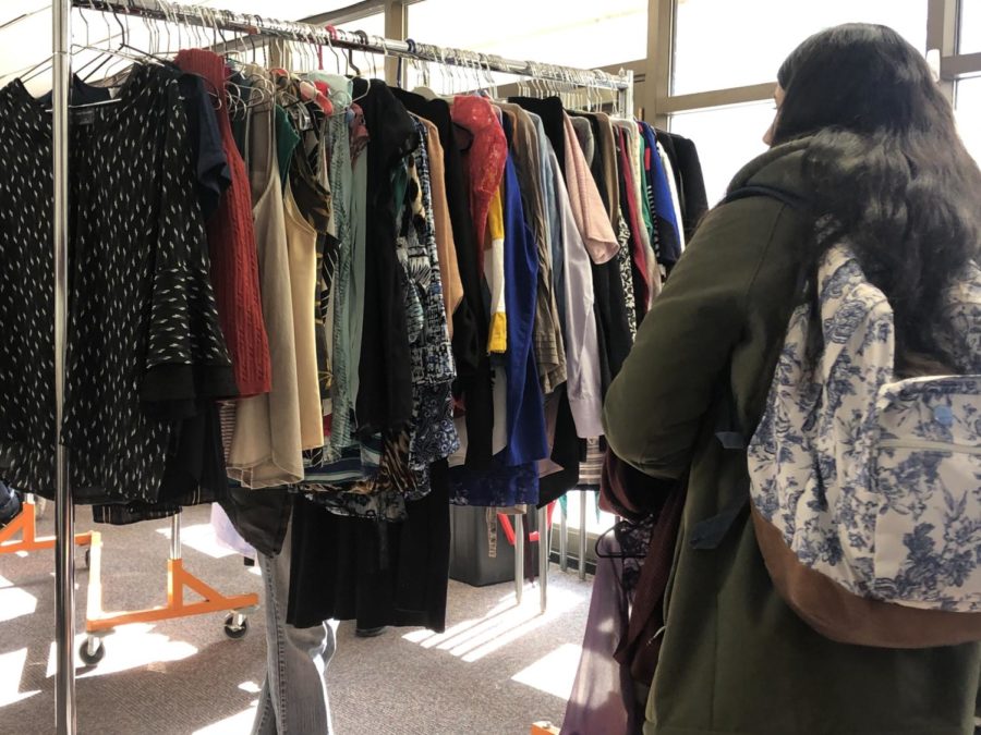 Katie Aguayo, sophomore in kinesiology and health, checking the wardrobe options at the Business Attire Pop-Up Shop in LeBaron Hall on Feb. 6.