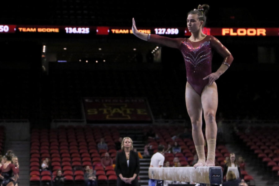Junior Molly Russ performs on the beam. The meet was held on Friday, March 15 in Hilton Coliseum with Denver winning 197.225 to 195.925.