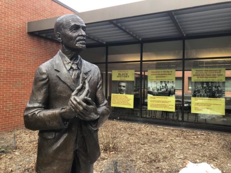 Posters of George Washington Carver accompany a statue of him outside of the Seed Science Center.