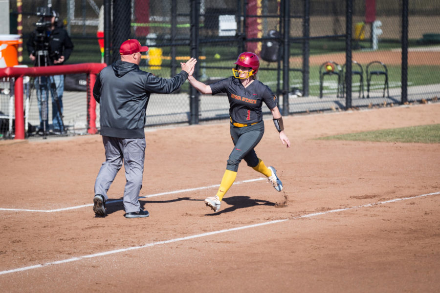 Iowa+State+freshman+Kasey+Simpson+high+fives+her+coach+as+she+rounds+third+following+her+first+home+run+of+the+Iowa+State+vs+South+Dakota+softball+game+held+at+the+Cyclone+Sports+Complex+April+2.+The+Cyclones+had+three+home+run+hits+and+defeated+the+Coyotes+9-1.