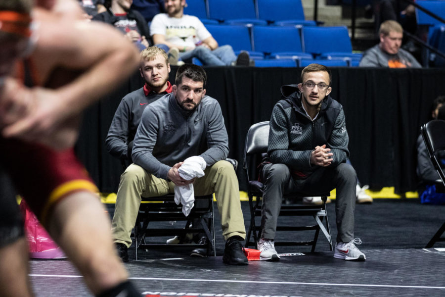 Assistant Head Coach Brent Metcalf and Graduate Assistant Coach Joey Palmer of Iowa State watch a match in the coaches corner on March 7 at the Big 12 Championships inside the Bank of Oklahoma Center in Tulsa