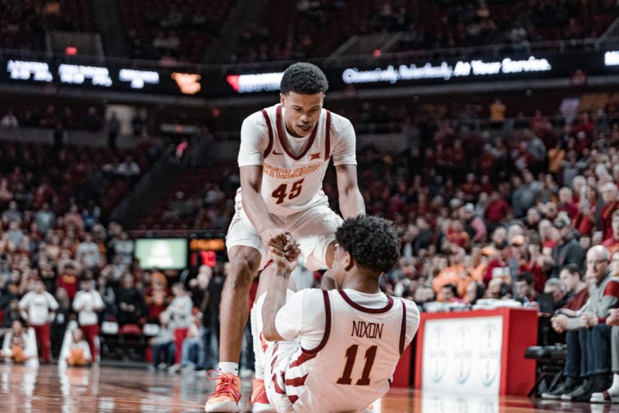 Rasir Bolton helps Prentiss Nixon up on March 3 against West Virginia in Iowa States final home game of the season at Hilton Coliseum.
