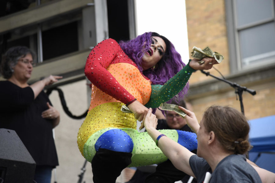 Jade Knight dances in a rainbow body suit and accepts dollar bills during her drag performance at Ames Pridefest 2019. 