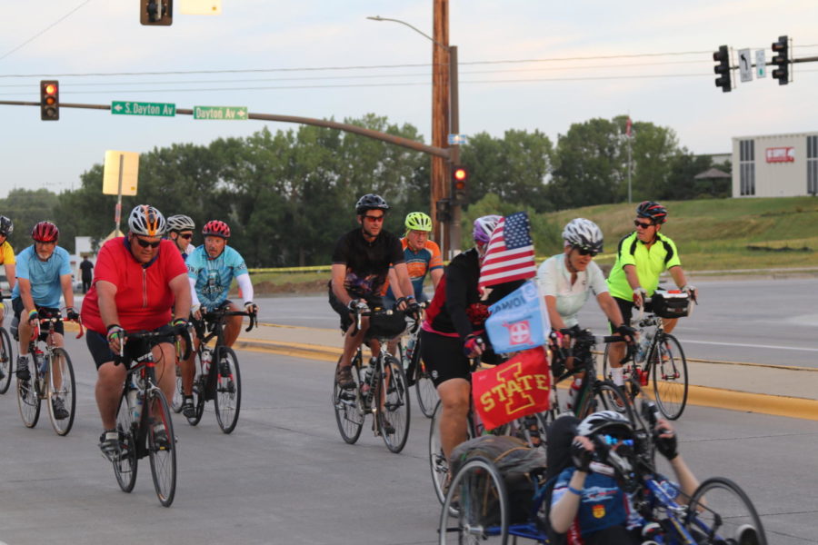 A+RAGBRAI+rider+is+seen+displaying+an+Iowa+State+flag+on+a+horizontal+tricycle+leaving+Ames+early+July+25%2C+2018.