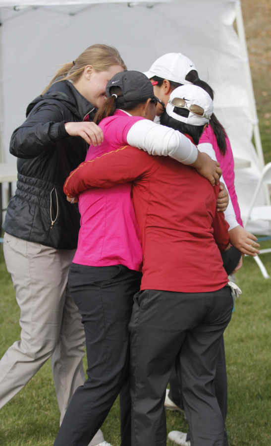 Members of the womens golf team embrace in a group hug after everyone completed their games during the 2013 Big 12 Womens Golf Championship at the Harvester on April 20, 2013, in Rhodes, Iowa.