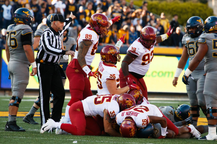 A group of Cyclone defenders recover a fumble in Iowa States 38-14 win over West Virginia on Oct. 12.