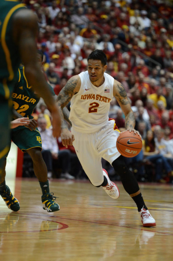 Chris Babb attempts to pass the Baylor players in the 79-71 win Feb. 2, 2013, at Hilton Coliseum. Babb had a total of 6 points in the game. 