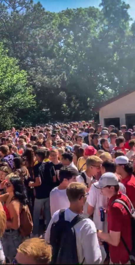 A large group of students gather at a house party without social distancing on 801 day.