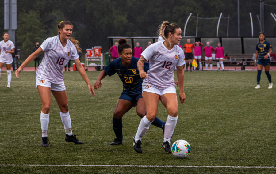 Eva+Steckelberg+dribbles+the+ball+upfield+against+West+Virginia+in+the+Cyclones+season+opener.+The+Cyclones+lost+to+the+Mountaineers+2-0+on+Friday.