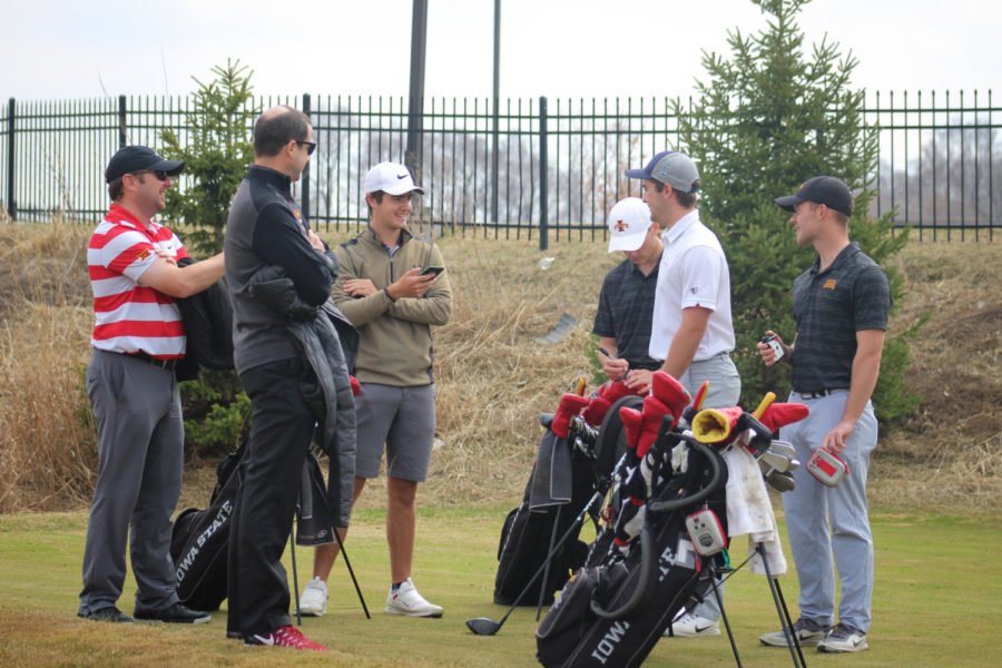 Part of the mens golf team talks and prepares to tee off on the first hole on April 5, 2019, at Coldwater Golf Links.