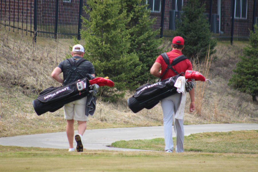 Senior Tripp Kinney and junior Ricky Costello walk to their golf balls after teeing off on the first hole April 5, 2019, at Coldwater Golf Links.