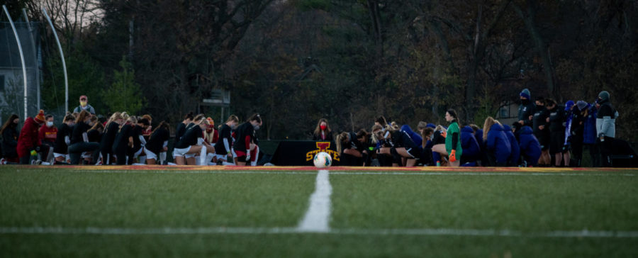 Players from the Iowa State soccer team and the Kansas State soccer team kneel at midfield during the national anthem on Oct 30, 2020.