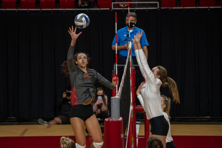 Iowa State redshirt junior middle blocker Avery Rhodes attempts to hit the ball over the net against Texas Tech on Oct. 3. Texas Tech beat Iowa State 3-2.