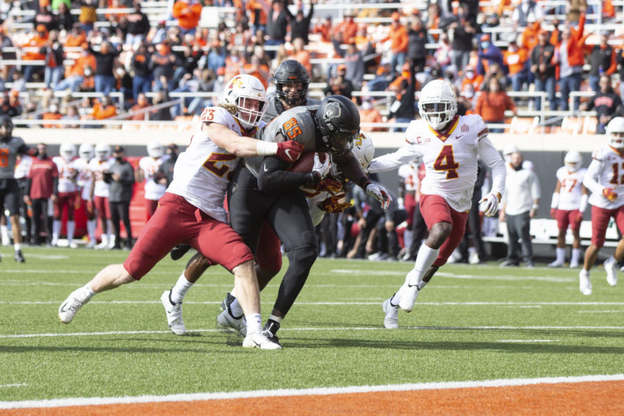 Iowa State linebacker Mike Rose tries to bring down Oklahoma States Jelani Woods during the Cyclones and Cowboys game Saturday in Stillwater, Oklahoma.