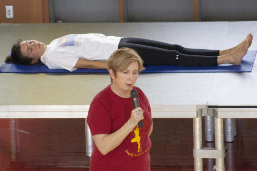 Nora Hudson, the assistant director of fitness for Iowa State Recreation Services, leads a deep relaxation exercise at the Yogathon grand finale. The Yogathon grand finale was held in the east basketball court at State Gym on Feb. 9, 2019.