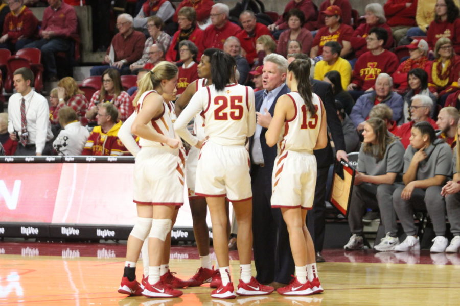 Head Coach Bill Fennelly meets with his players during a timeout in a game against Iowa on Dec. 11.