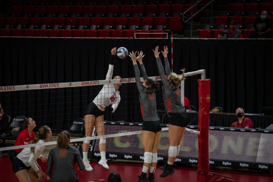 Candelaria Herrera (left) and Eleanor Holthaus (right) team up for a block against Texas Tech on Oct. 3. Iowa State lost the match 3-2.