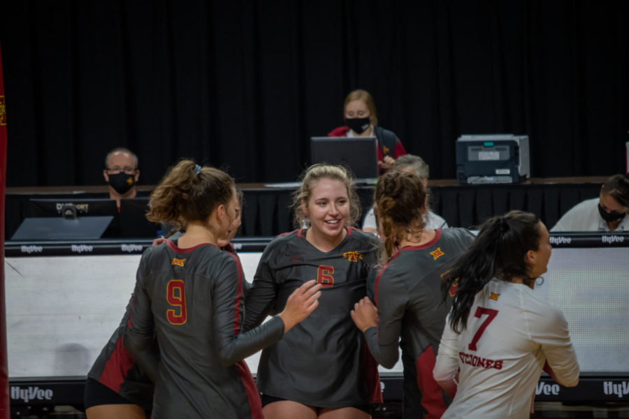 Eleanor Holthaus and her teammates gather after a point victory against Texas Tech on Oct. 3.