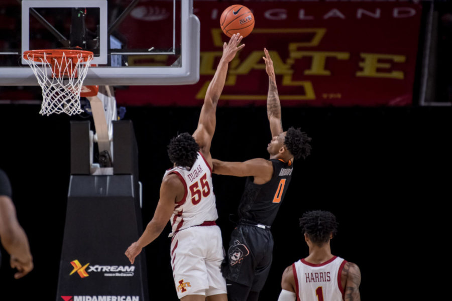Iowa State freshman Darlinstone Dubar attempts to block Oklahoma States Avery Andersons shot attempt in Iowa State mens basketballs game against the Cowboys on Monday.