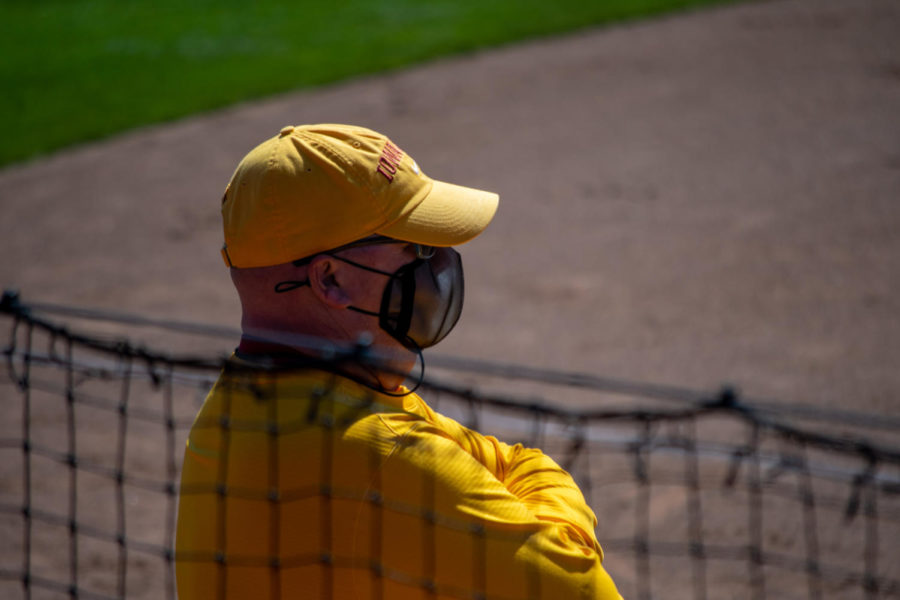 Iowa State softball Head Coach Jamie Pinkerton looks out to the infield, watching the game against the University of Oklahoma on March 28 at the Cyclone Sports Complex.