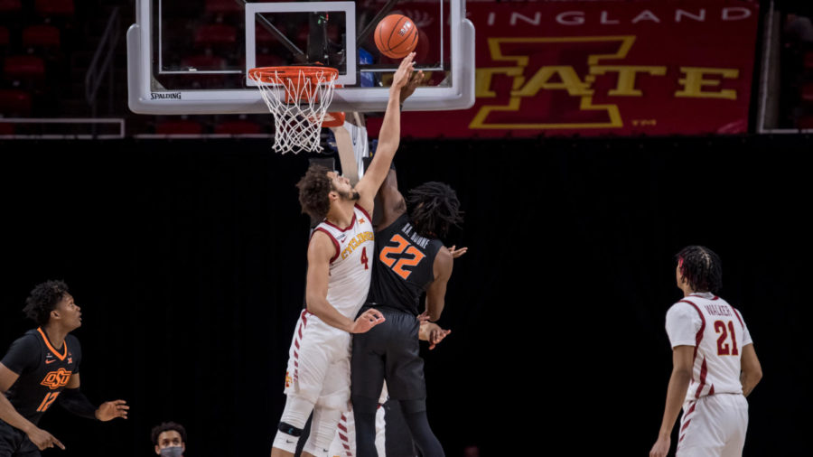 Junior forward George Conditt attempts to block Kalib Boones shot attempt in an 81-60 loss against the Oklahoma State Cowboys on Jan. 25.