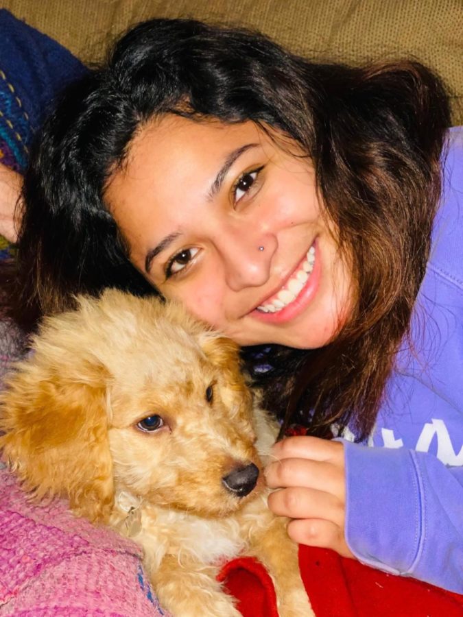 The body found Friday morning was identified to be that of Iowa State student Olivia Chutich, pictured with her dog Winston.