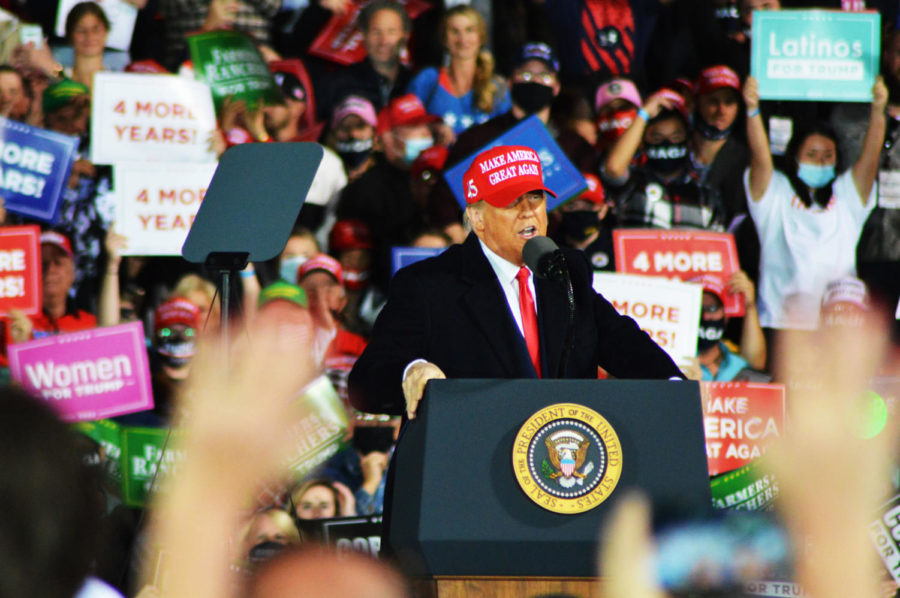 President Donald Trump wears a Make America Great Again hat at a rally Oct. 14 at the Des Moines International Airport.