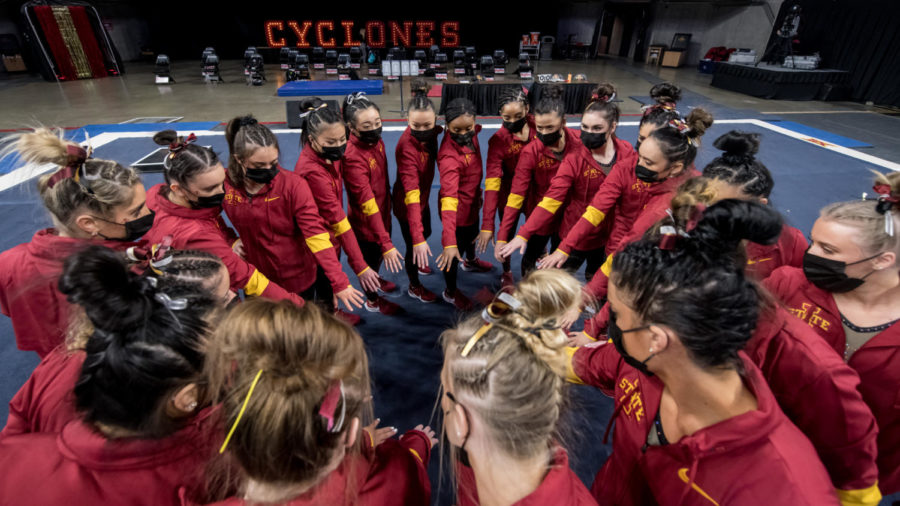 Members of the Iowa State gymnastics team huddle together before the gymnastics meet between Iowa State and Denver on Jan. 15 in Hilton Coliseum.