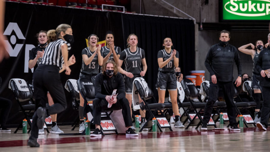 From left to right: Maddie Frederick, Maggie Espenmiller-McGraw, Kristen Scott, Emily Ryan and Kylie Feuerbach cheer on their teammates from the bench against the University of Oklahoma on Jan. 19.