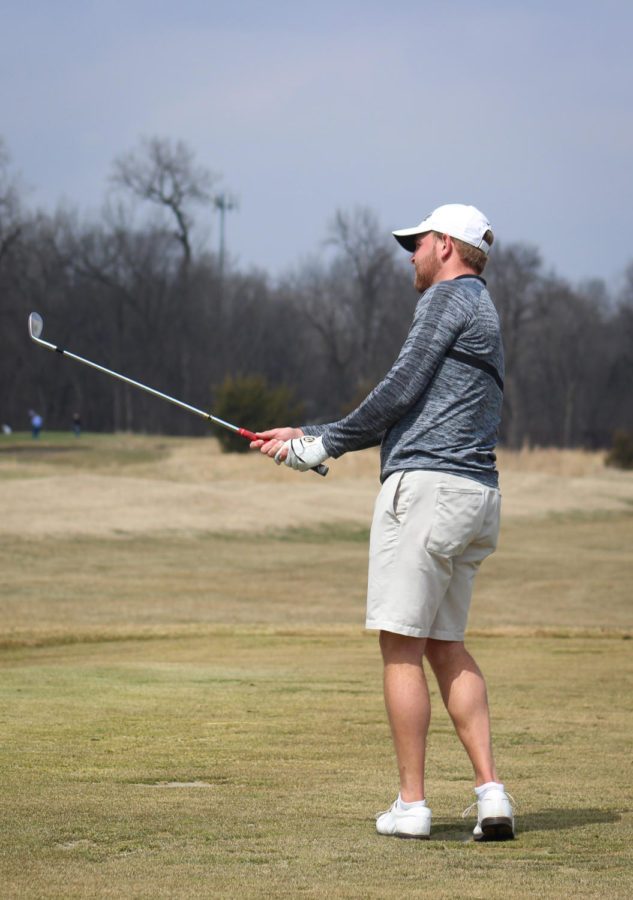 Tripp Kinney chips the ball onto the practice green April 5, 2019.