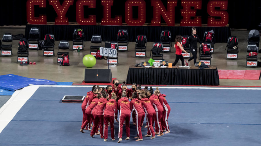 The Iowa State gymnastics team huddles together before its meet against Northern Illinois University on March 12 at Hilton Coliseum.