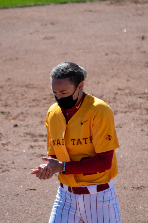 Skyler Ramos rubs her hands together to keep warm during the windy game against Oklahoma on March 28th.