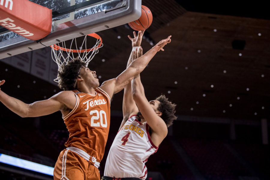 Texas forward Jericho Sims attempts to block George Conditts shot attempt Tuesday at Hilton Coliseum. (Photo courtesy of Luke Lu/Iowa State Athletics)