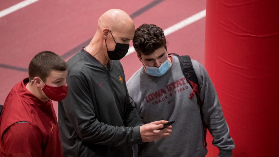 Iowa State track and field associate head coach talks with redshirt freshman Joe Ryan during the Iowa State Classic on Feb. 12.