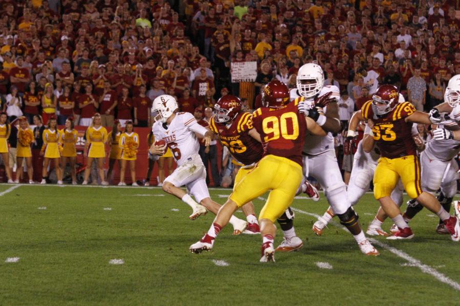 Former Texas quarterback Case McCoy gets chased down by Iowa States then-redshirt sophomore defensive end Nick Kron (No. 69) during the Cyclones 31-30 loss to the Longhorns on Oct. 3, 2013, at Jack Trice Stadium.